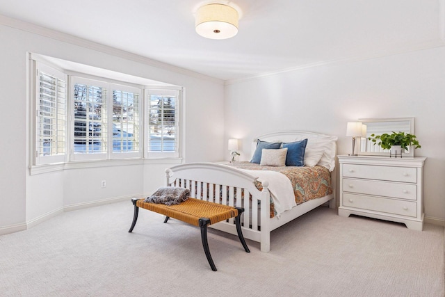 bedroom featuring light carpet, baseboards, and ornamental molding