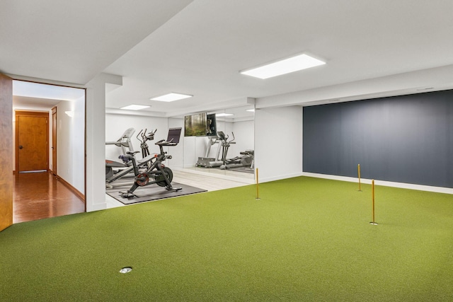 workout area featuring carpet flooring and baseboards