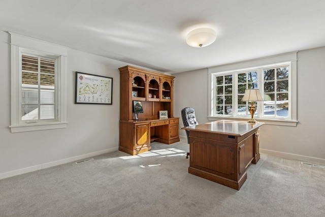 office with visible vents, light colored carpet, and baseboards