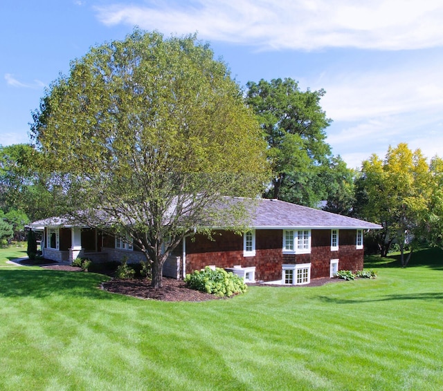 rear view of house with a yard