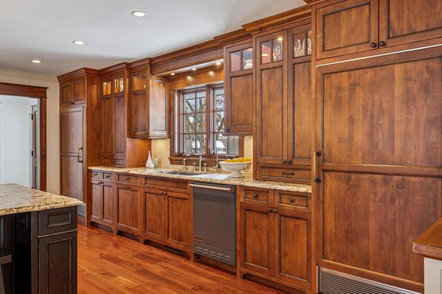 6601 Dovre Dr, Edina, MN 55436 - kitchen with dishwasher, wood finished floors, a sink, glass insert cabinets, and light stone counters