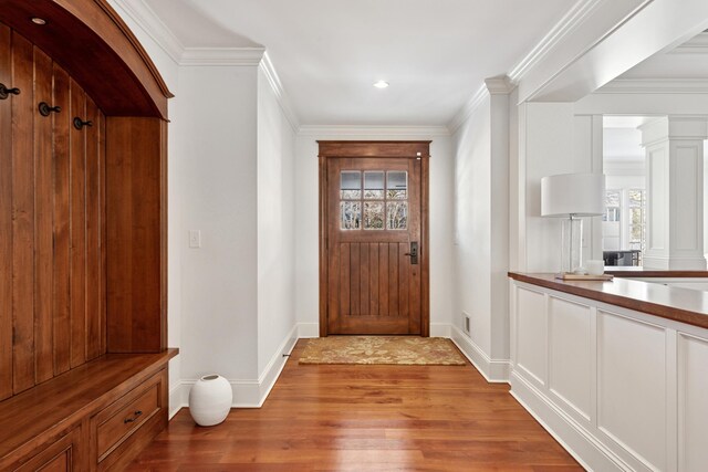 6601 Dovre Dr, Edina, MN 55436 - mudroom with wood finished floors, plenty of natural light, decorative columns, baseboards, and crown molding