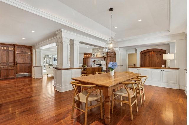 6601 Dovre Dr, Edina, MN 55436 - dining space with decorative columns, dark wood finished floors, a fireplace, ornamental molding, and recessed lighting