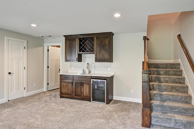 bar featuring wine cooler, stairway, wet bar, and light colored carpet