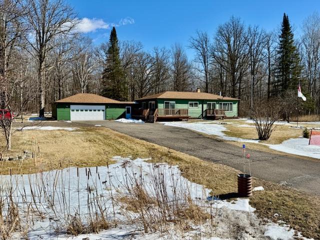 view of front of property with a garage and a wooden deck