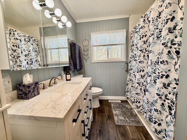 full bath with crown molding, toilet, vanity, a textured ceiling, and wood finished floors