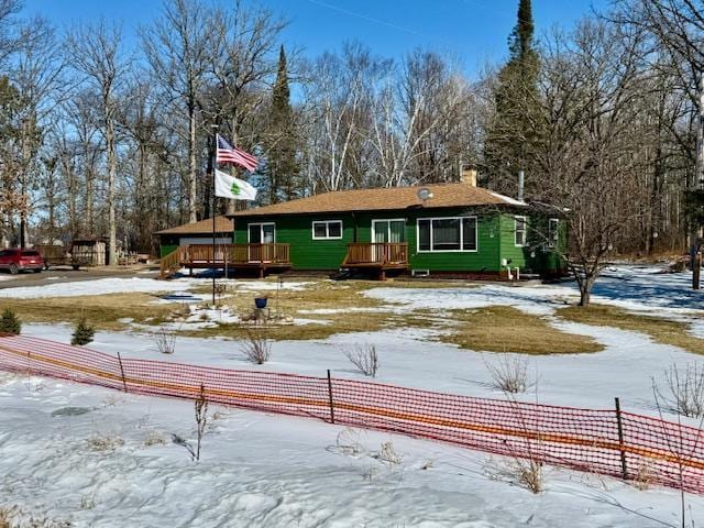 view of front of house with fence and a wooden deck