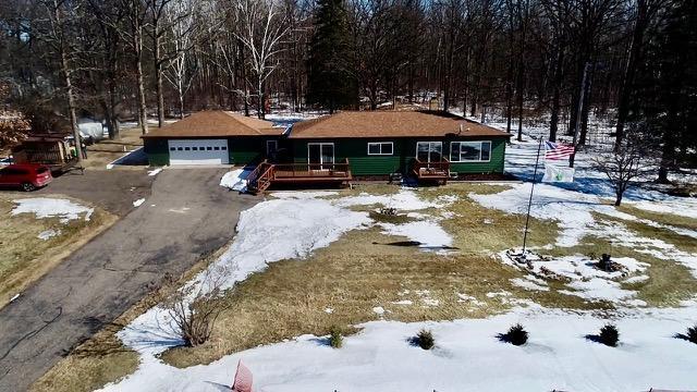 ranch-style home with a garage and driveway