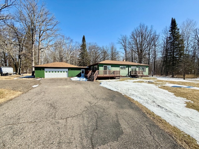 view of front of property with a garage and a deck