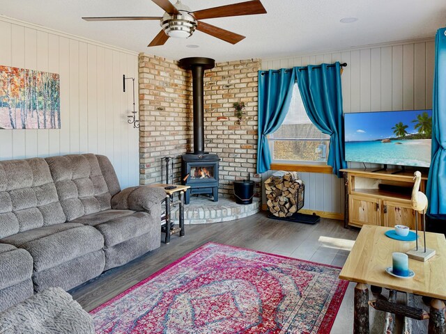 45936 State Highway 65, Mcgregor, MN 55760 - living area with ceiling fan, wood finished floors, a wood stove, and wood walls