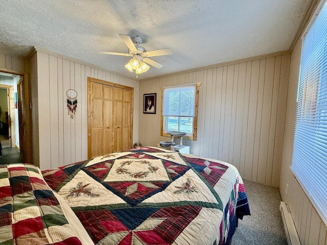 45936 State Highway 65, Mcgregor, MN 55760 - bedroom featuring carpet flooring, crown molding, a textured ceiling, a baseboard radiator, and wood walls