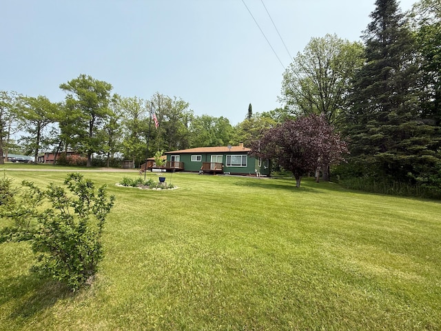 45936 State Highway 65, Mcgregor, MN 55760 - view of green lawn featuring a wooden deck