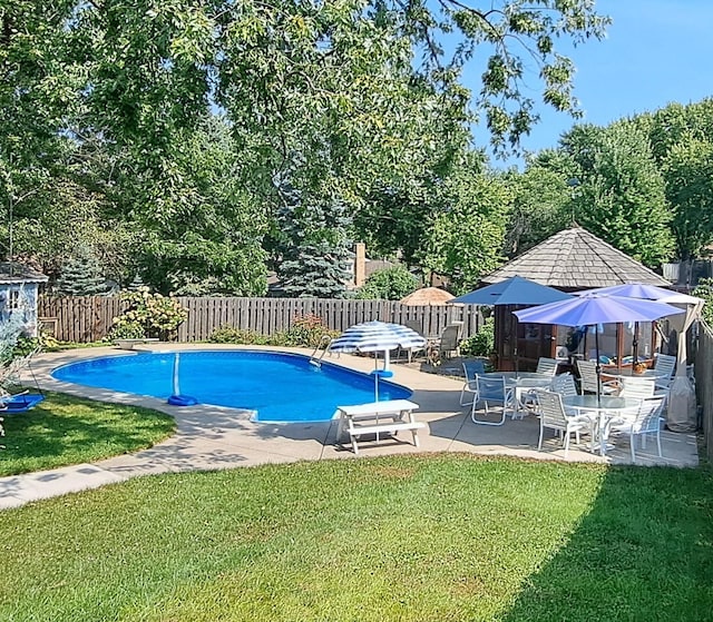 view of pool featuring a patio area, a fenced backyard, a fenced in pool, and a yard