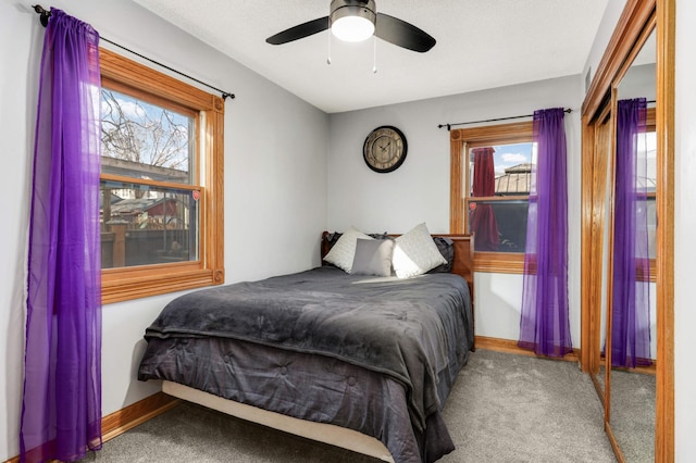 bedroom with multiple windows, carpet flooring, and baseboards