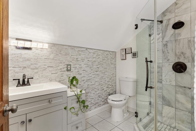 bathroom with tile patterned floors, toilet, a stall shower, vanity, and vaulted ceiling