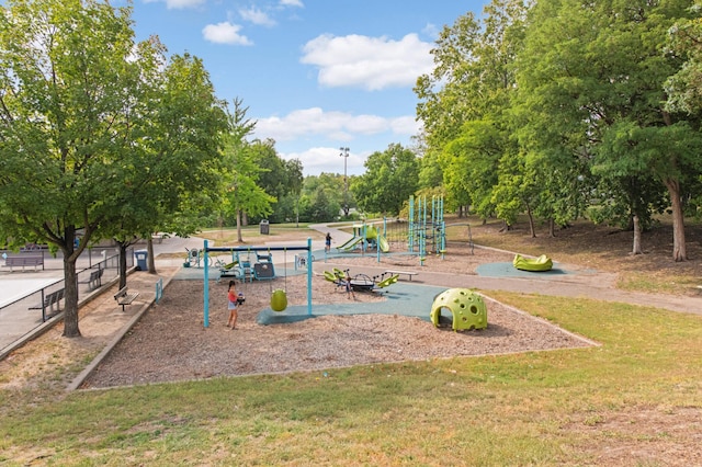 community jungle gym featuring a lawn