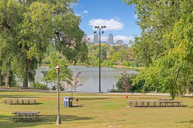 surrounding community with a view of city, a lawn, and a water view