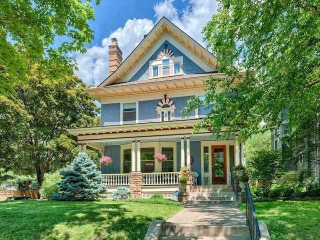 857 Fairmount Ave, Saint Paul, MN 55105 - victorian house with a porch, a chimney, and a front lawn
