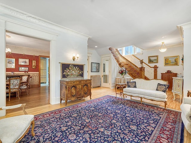 857 Fairmount Ave, Saint Paul, MN 55105 - living room with ornamental molding, wood finished floors, stairway, and radiator