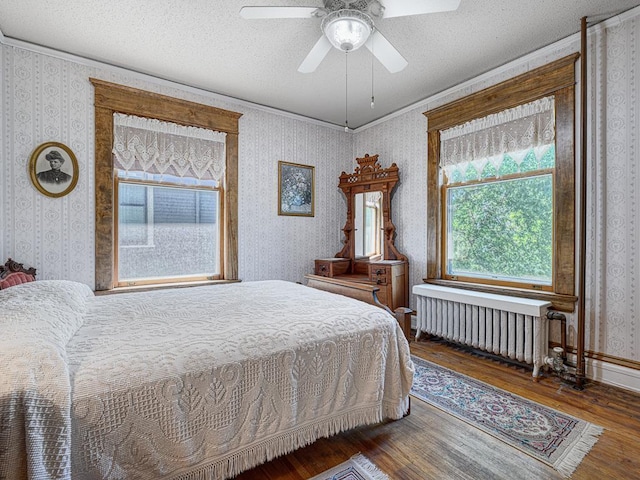 857 Fairmount Ave, Saint Paul, MN 55105 - bedroom with radiator, wallpapered walls, wood finished floors, crown molding, and a textured ceiling