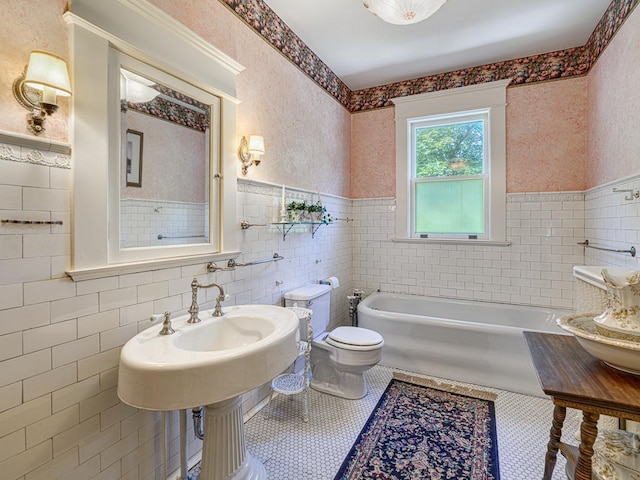 857 Fairmount Ave, Saint Paul, MN 55105 - full bath with tile walls, a wainscoted wall, a garden tub, and tile patterned flooring