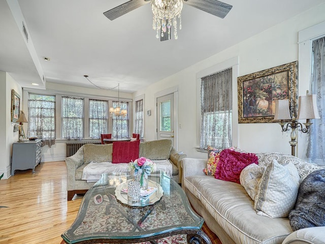 857 Fairmount Ave, Saint Paul, MN 55105 - living area with a ceiling fan, a chandelier, light wood finished floors, and radiator heating unit
