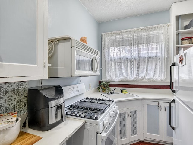 857 Fairmount Ave, Saint Paul, MN 55105 - kitchen featuring white appliances, light countertops, and a textured ceiling