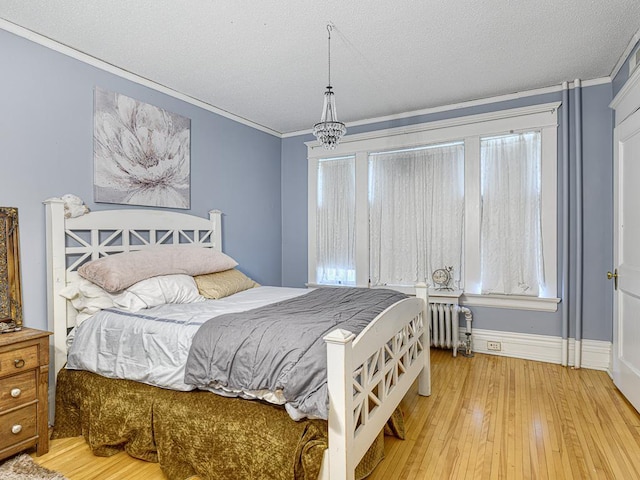857 Fairmount Ave, Saint Paul, MN 55105 - bedroom with radiator heating unit, ornamental molding, a textured ceiling, hardwood / wood-style flooring, and multiple windows