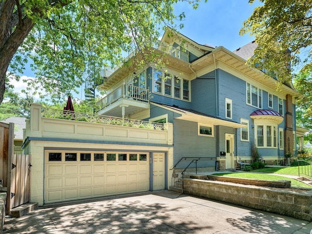 857 Fairmount Ave, Saint Paul, MN 55105 - view of front facade with a balcony, driveway, and a garage