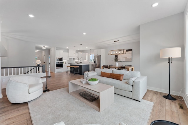 17771 Elkwood Ct, Lakeville, MN 55024 - living area featuring light wood-style floors, recessed lighting, and baseboards