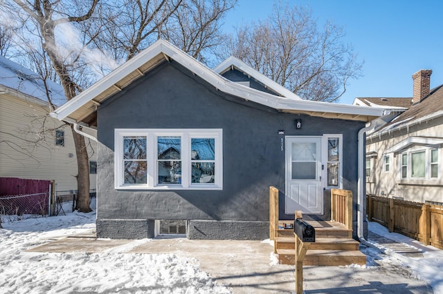 view of front of property with fence and stucco siding