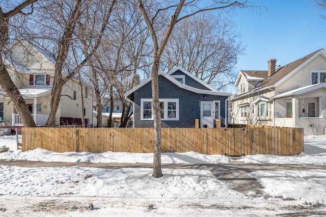 exterior space with a fenced front yard and stucco siding