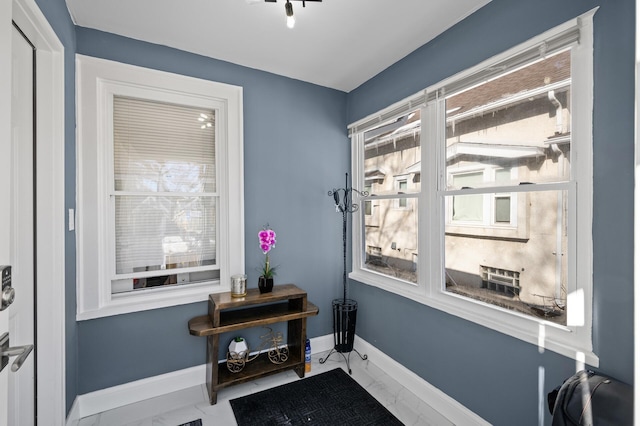 interior space with marble finish floor and baseboards