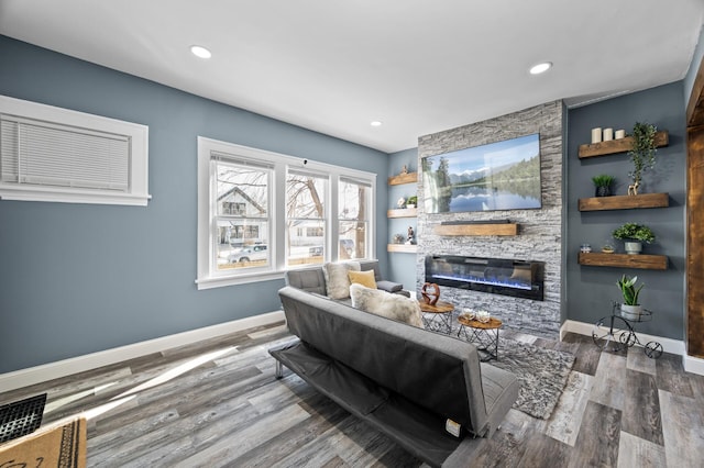 living room with a fireplace, recessed lighting, visible vents, wood finished floors, and baseboards