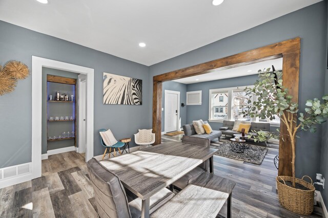 dining area with baseboards, wood finished floors, and recessed lighting