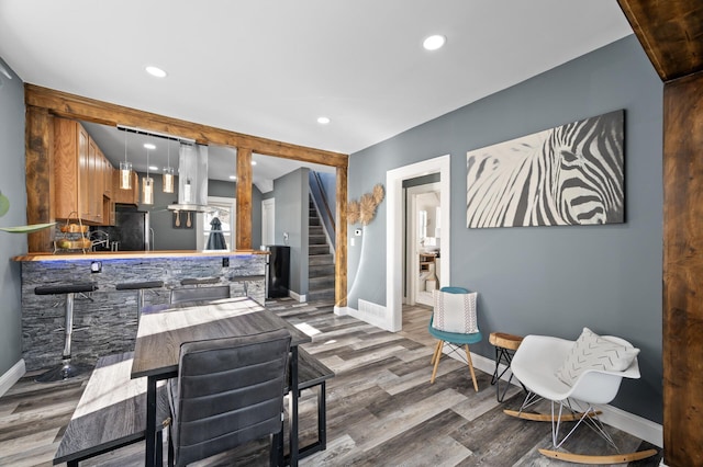 living area featuring recessed lighting, stairway, baseboards, and wood finished floors