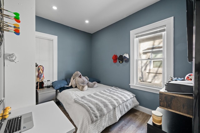 bedroom with baseboards, wood finished floors, and recessed lighting