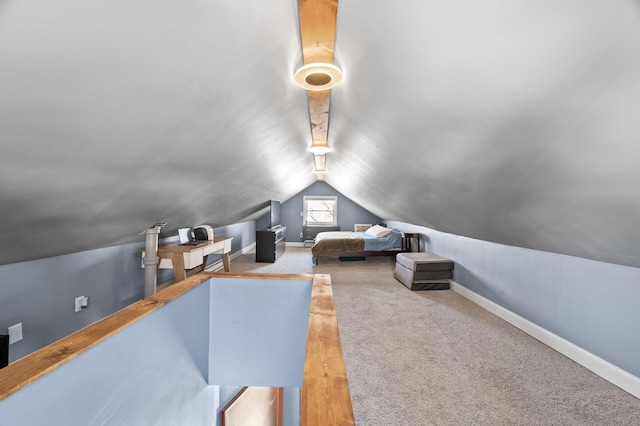 bedroom with lofted ceiling, carpet flooring, and baseboards