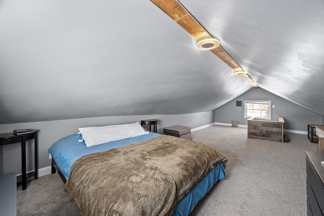 bedroom with lofted ceiling and baseboards