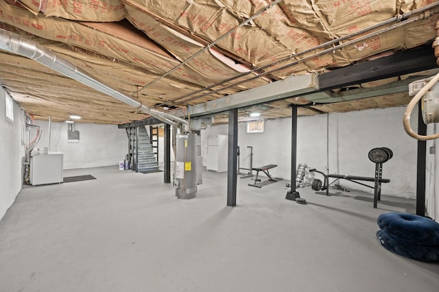 basement with stairway, gas water heater, and washer / dryer