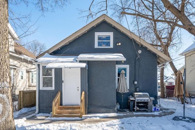 bungalow-style house featuring entry steps and fence