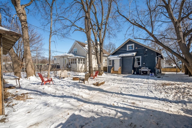 view of front of house with fence and a fire pit