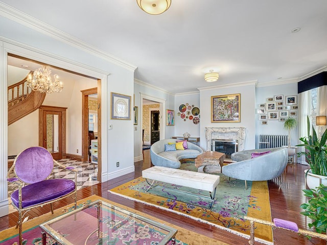 living room with hardwood / wood-style floors, radiator, baseboards, a fireplace, and crown molding