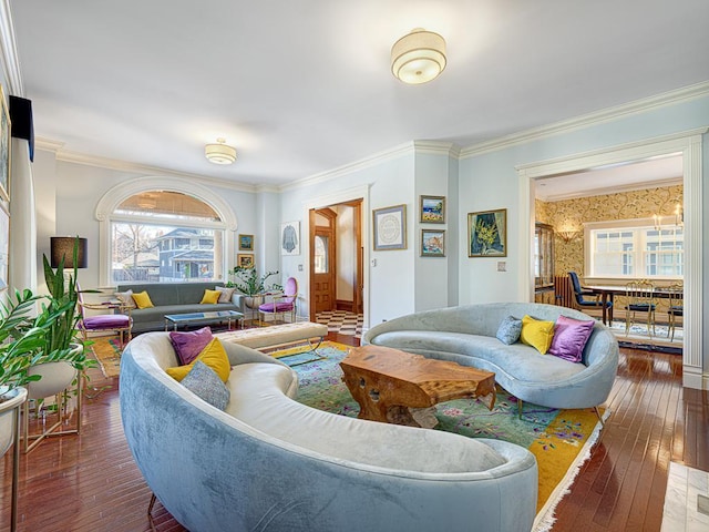 living area featuring hardwood / wood-style floors, wallpapered walls, and ornamental molding