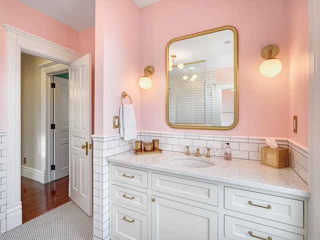 bathroom featuring vanity, tile walls, a wainscoted wall, and tile patterned floors