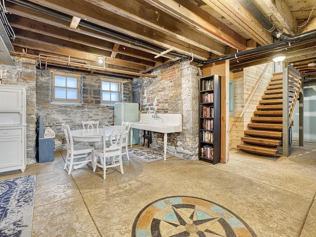 basement featuring stairs and a sink