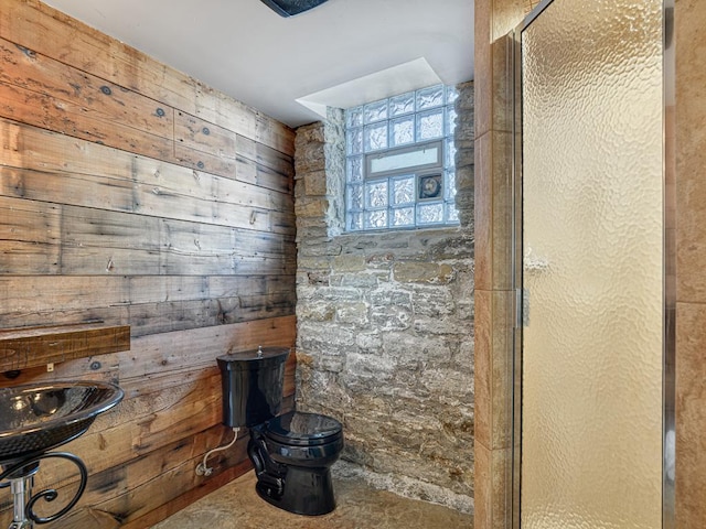 full bath featuring an enclosed shower, toilet, and wooden walls