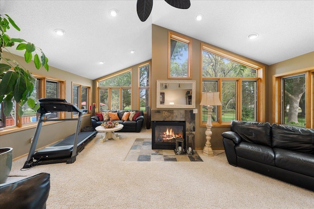 carpeted living area with lofted ceiling, a textured ceiling, recessed lighting, a fireplace, and baseboards