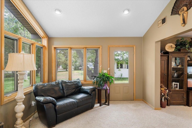 living room featuring baseboards, visible vents, light colored carpet, vaulted ceiling, and recessed lighting