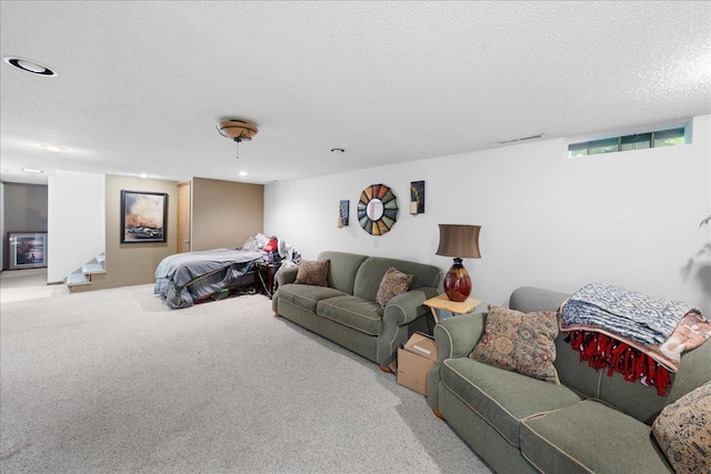 carpeted living room featuring stairs, visible vents, a textured ceiling, and recessed lighting